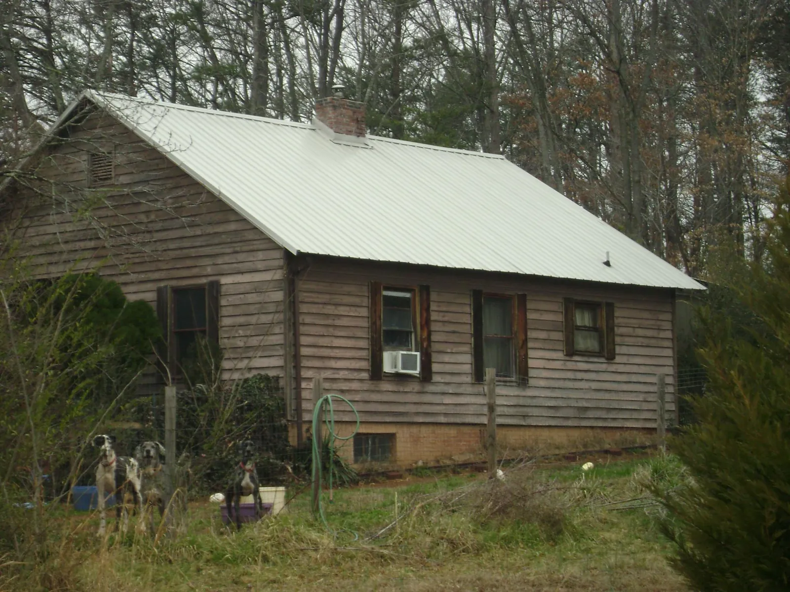 White metal roof on an old wood sided farmhouse, from a Asphalt Shingle Roof Repair job in Barnesville